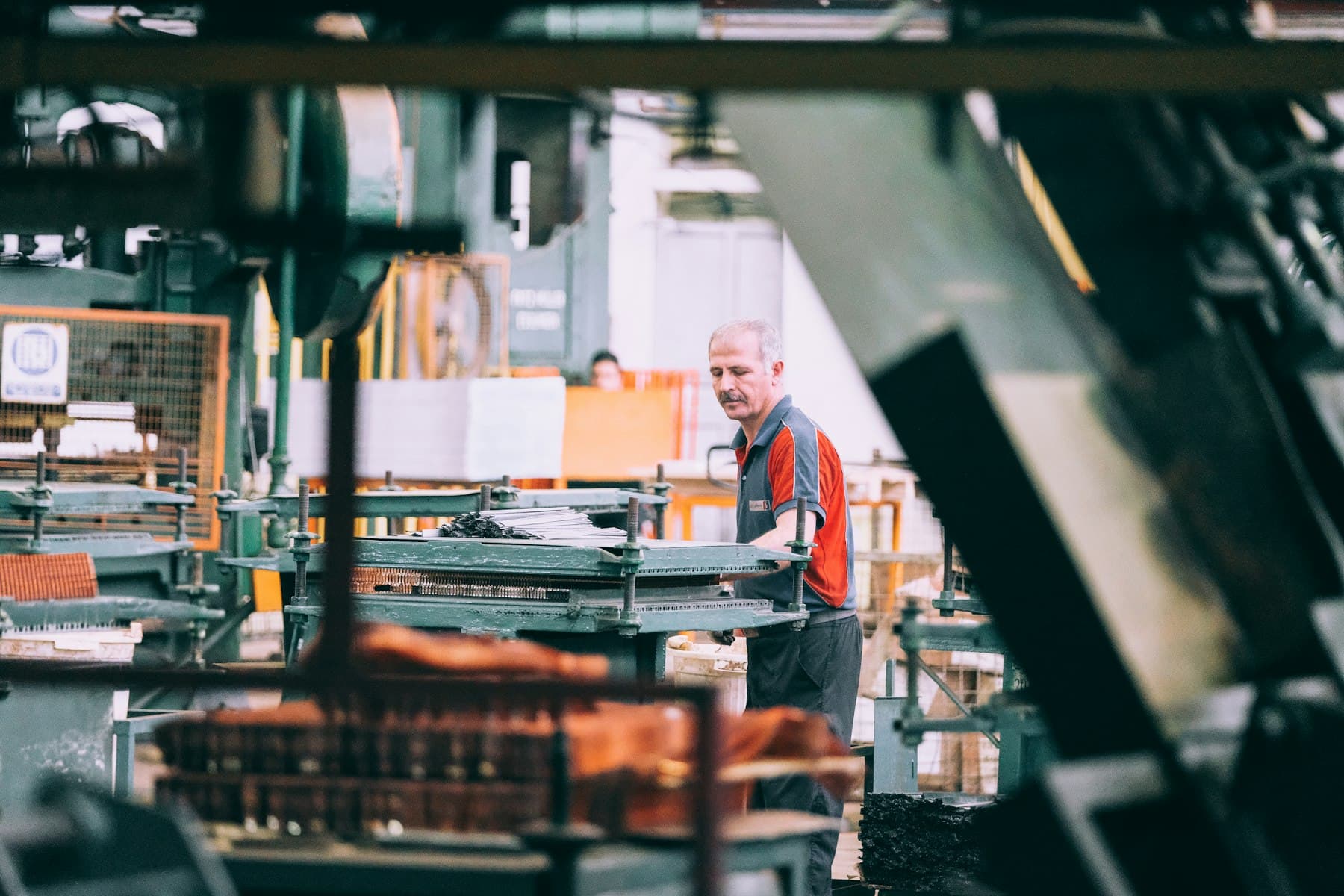 Technician operating industrial machinery inside a factory